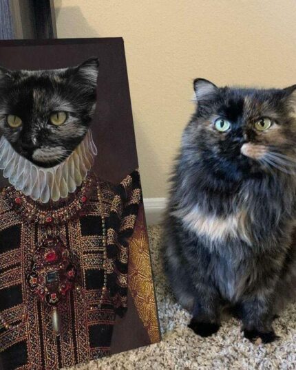 A fluffy tortoiseshell cat sits on a carpet beside The Yellow Queen #7 - Custom Design Pet Canvas, displaying its portrait in an ornate historical costume with a ruffled collar and jeweled gown.