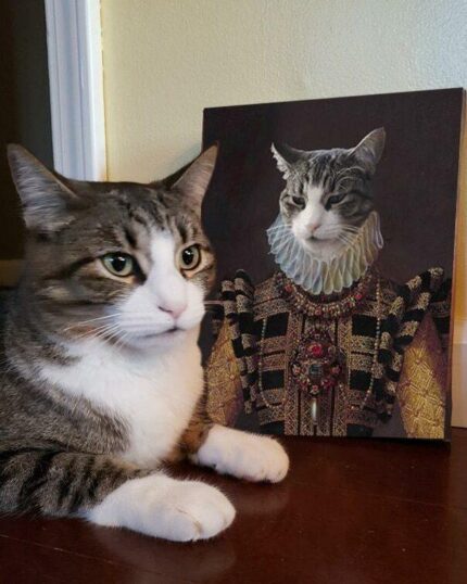A tabby cat lounges next to "The Yellow Queen #7 - Custom Design Pet Canvas," featuring its portrait in royal attire, humorously highlighting the unique charm of personalized pet artwork.