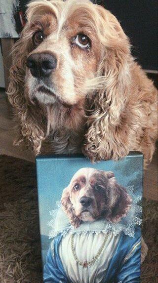 A brown and white dog with long, curly ears poses beside The Pink Noble Lady #11 - Custom Design Pet Canvas, displaying its portrait in elegant, regal attire adorned with lace and jewelry. The dog's paw rests proudly on the canvas.