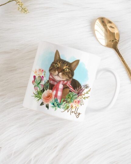 The Flower Wreath Custom Design Mug #1 displays a custom cat portrait, flowers, and the name Molly. It rests on a white furry surface beside a gold spoon and dried flowers.