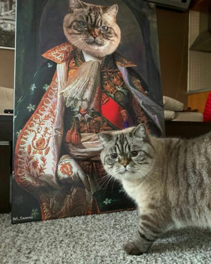 A cat poses in front of "The King #3 - Custom Design Canvas Painting," its face perfectly matched to the regal portrait. The real pet and the expertly printed masterpiece share an impressive likeness on this unique canvas.