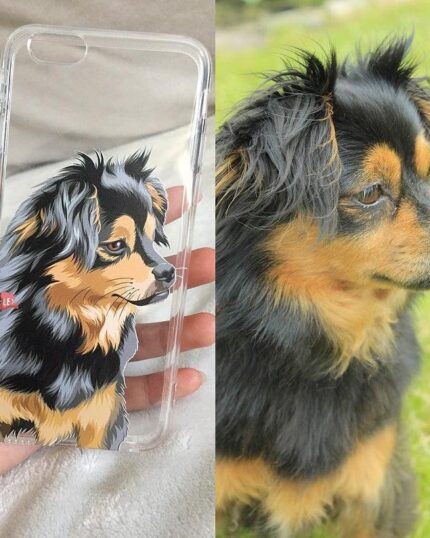 A Personalized Transparent Phone Case featuring an illustrated black and tan dog is held by hand, shown beside a photo of the real dog on green grass. The custom design captures the pet’s unique look perfectly.
