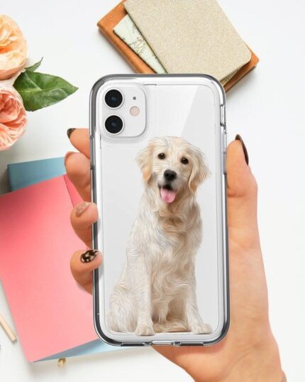 A hand holds a Personalized Transparent Phone Case with a golden retriever illustration inspired by custom pet canvas art. In the background, pink roses, colored notebooks, and a pen are on a white surface.