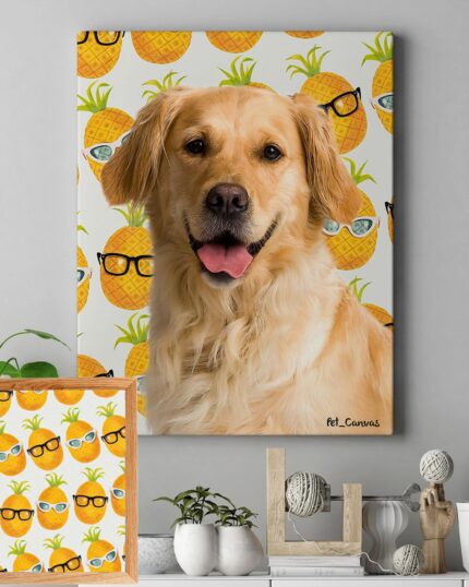 A framed "Pop Art – Fruits" custom pet canvas of a golden retriever is displayed on a wall, featuring cartoon pineapples in sunglasses and surrounded by plants, books, décor, and a coordinating pineapple-themed frame below.