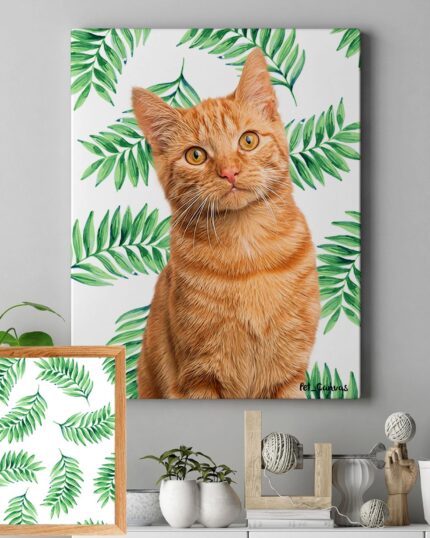 A framed "Pop Art – Leaves" canvas featuring an orange cat with green eyes hangs on a leaf-patterned wall. Below, a smaller matching frame sits among plants and decor items on a gray surface.