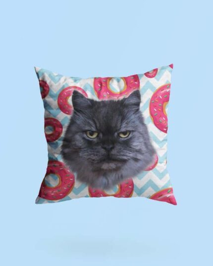 The Personalized Pop Art Pillow – Donut showcases a grumpy gray cat's face with pink frosted donuts and blue chevron stripes on a light blue background—ideal for custom design pet canvas art lovers.