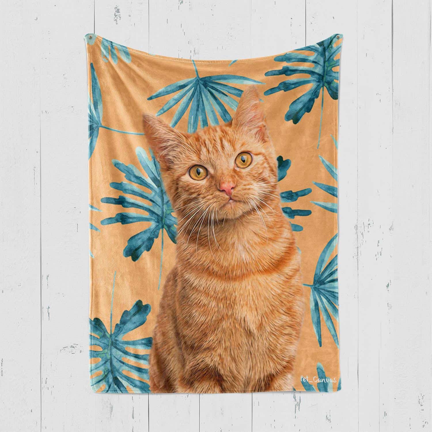The Custom Design Pop-Art Blanket – Leaf #10 Showcases A Lifelike Orange Tabby Cat On A Tan Backdrop With Bold Blue Tropical Leaves, Perfect For Hanging On A White Wooden Wall. The Custom Design Pop-Art Blanket – Leaf #10 showcases a lifelike orange tabby cat on a tan backdrop with bold blue tropical leaves, perfect for hanging on a white wooden wall.