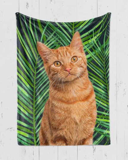 A Personalized Pop-Art Blanket – Leaf Collection featuring an orange tabby cat with green eyes sitting before lush green palm leaves, beautifully displayed.