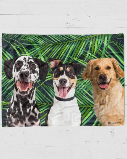 Three happy dogs—a Dalmatian, a black and white mixed breed, and a golden retriever—sit before green palm leaves on a white wooden surface, featured on the Custom Design Pop-Art Blanket – Leaf #2.