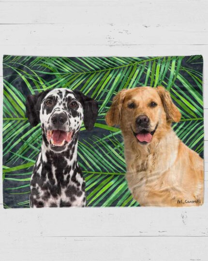 A Custom Design Pop-Art Blanket – Leaf #2 featuring illustrations of a Dalmatian and a Golden Retriever smiling side by side, with green palm leaves in the background on a white wooden surface.