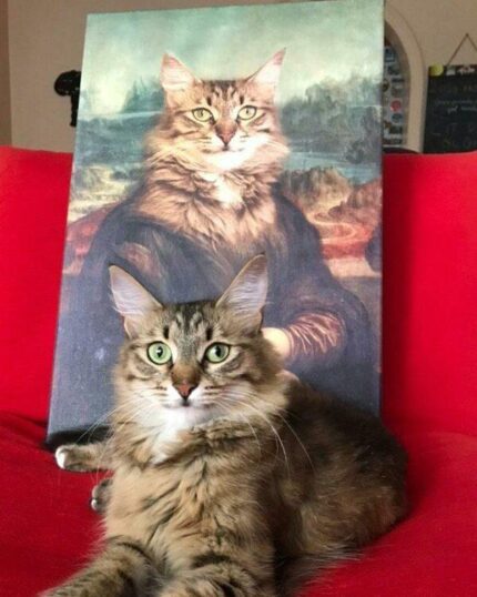 A fluffy brown tabby cat sits on a red couch in front of "The Mona Lisa #1 - Custom Pet Canvas," which portrays the cat as the Mona Lisa, perfectly capturing the iconic pose and expression.