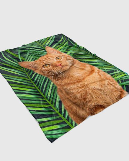 The Custom Design Pop-Art Blanket – Leaf #2 features a realistic orange tabby cat sitting among green palm leaves, inspired by custom pet canvas art and detailed canvas printing.