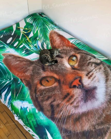 A small tabby kitten lies on a Custom Design Pop-Art Blanket – Leaf #3, its realistic cat face and green leaves blending amusingly with the real kitten for a fun, custom look.