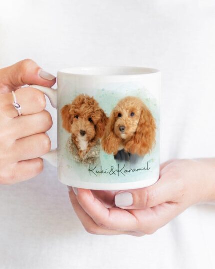 A person holds the Flower Wreath Custom Design Mug #6, a white mug with illustrations of two brown poodle-like dogs and "Kuki & Karamel" beneath, ideal for fans of personalized pet canvas art.