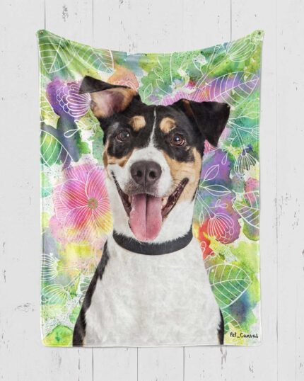 A happy black, white, and tan dog with big ears and its tongue out sits in front of a colorful floral background on the Custom Design Pop-Art Blanket – Magical Flowers.