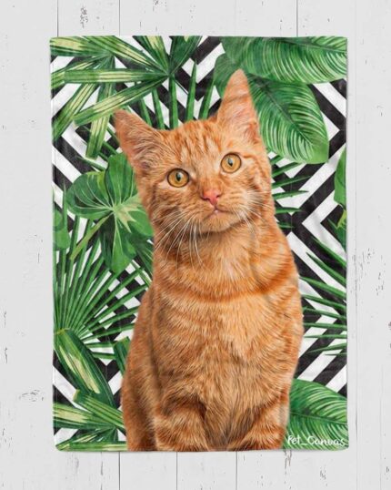 A ginger tabby cat sits before green tropical leaves and black-and-white stripes on the Custom Design Pop-Art Blanket – Leaf #4, displayed against a white wooden wall.