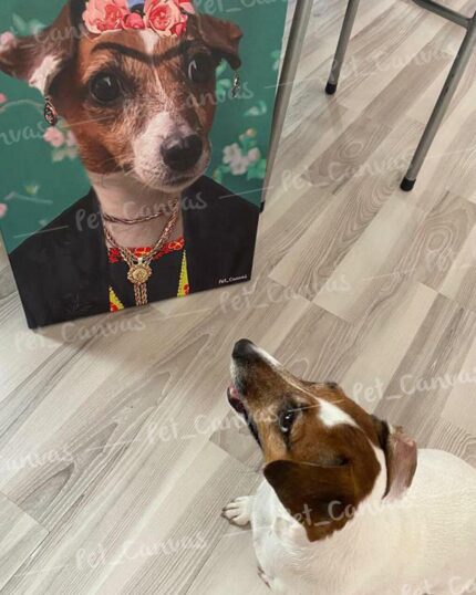 A dog looks up at The Frida Kahlo - Custom Design Pet Canvas, showing its regal portrait with jewelry, earrings, and a flower crown on a green background, placed on a light wooden floor next to a chair.
