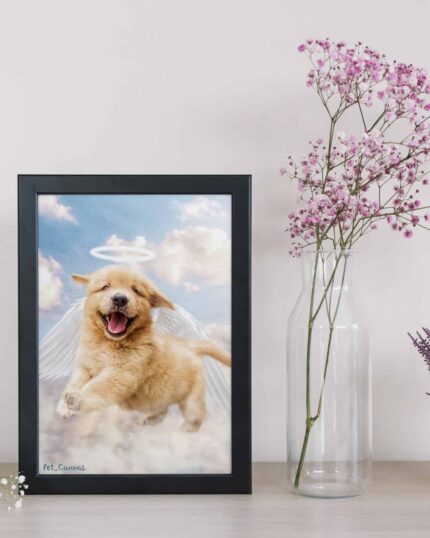 The Angel #2 - Custom Design Pet Canvas, featuring a golden retriever puppy with angel wings and a halo, is displayed on a table beside pink flowers in a glass vase and a small plant against a light pink wall.