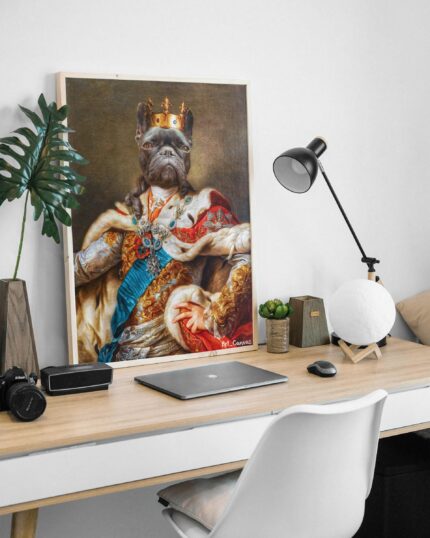 A framed portrait from "The Mighty King #7 - Custom Design Pet Canvas" shows a French bulldog as royalty—crown and robes—displayed on a modern desk with a laptop, lamp, and decor in a minimalist workspace.