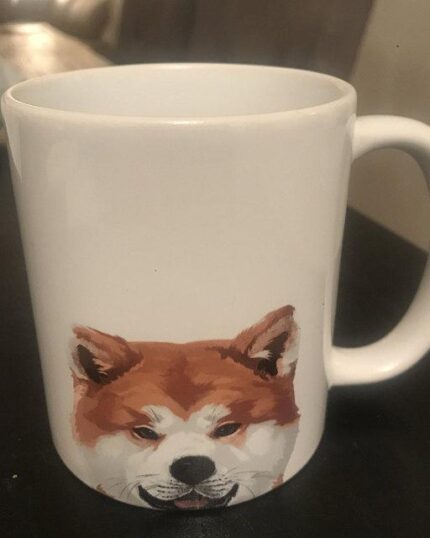 The Minimalist Black & White Design Mug features a printed illustration of a Shiba Inu dog’s face, making it a charming gift for pet lovers and canvas printing fans.