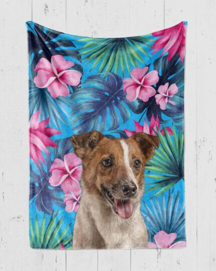 The Custom Design Pop-Art Blanket – Tropical Pattern features vibrant blue and green palm leaves, pink hibiscus flowers, and a custom pet canvas-style illustration of a happy brown and white dog in the center.