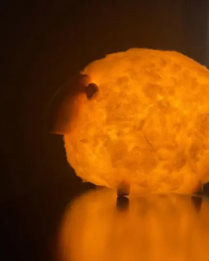 The Soft Cotton Sheep Night Light glows warmly with yellow-orange light, casting a soft reflection—perfect cozy inspiration for your custom pet canvas or pet canvas designs.