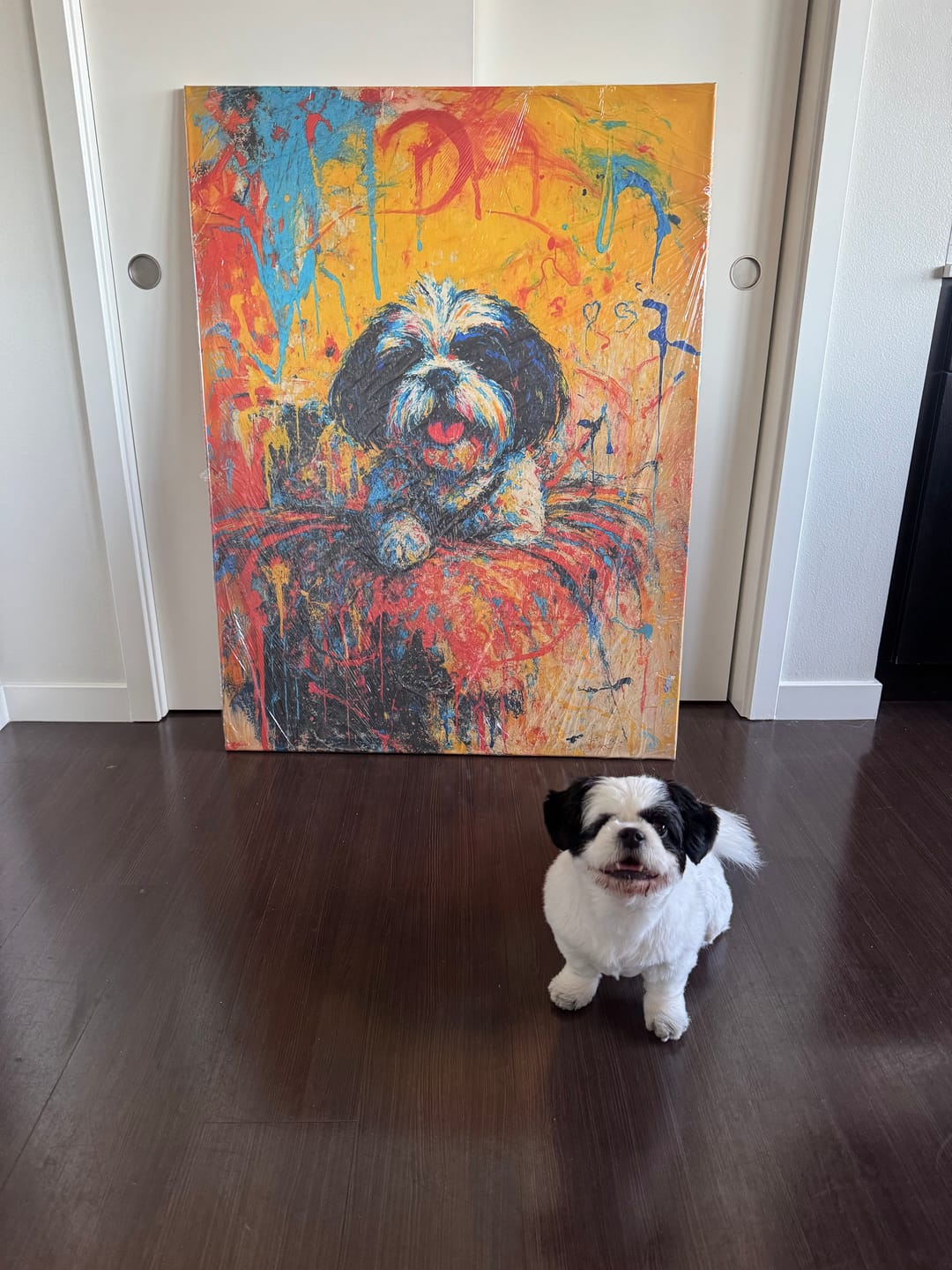 A dog sitting in front of a painting of an abstract painting of itself